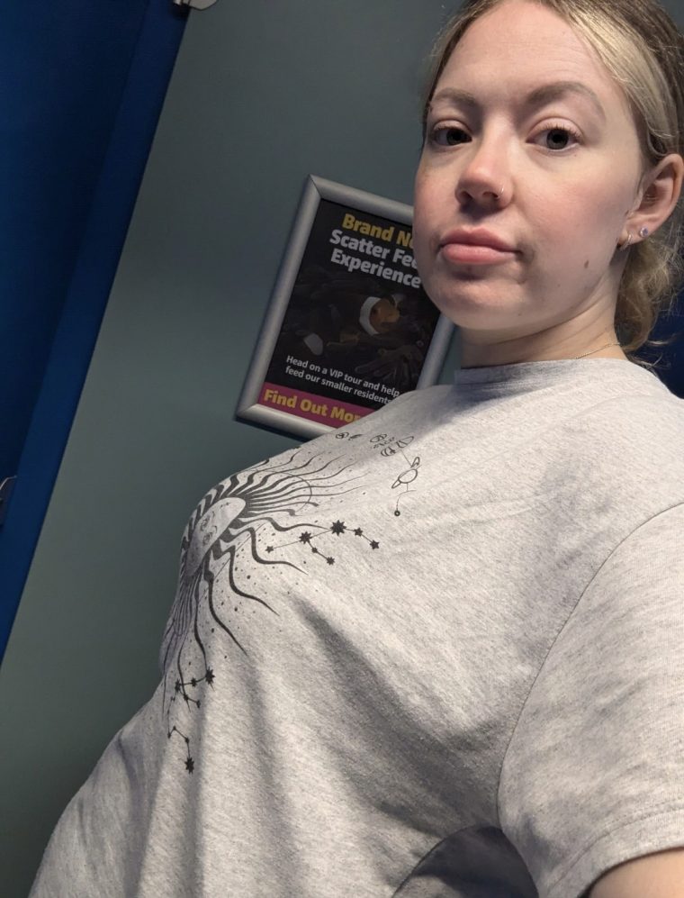 Image of a mum wearing breast pumps under her clothes